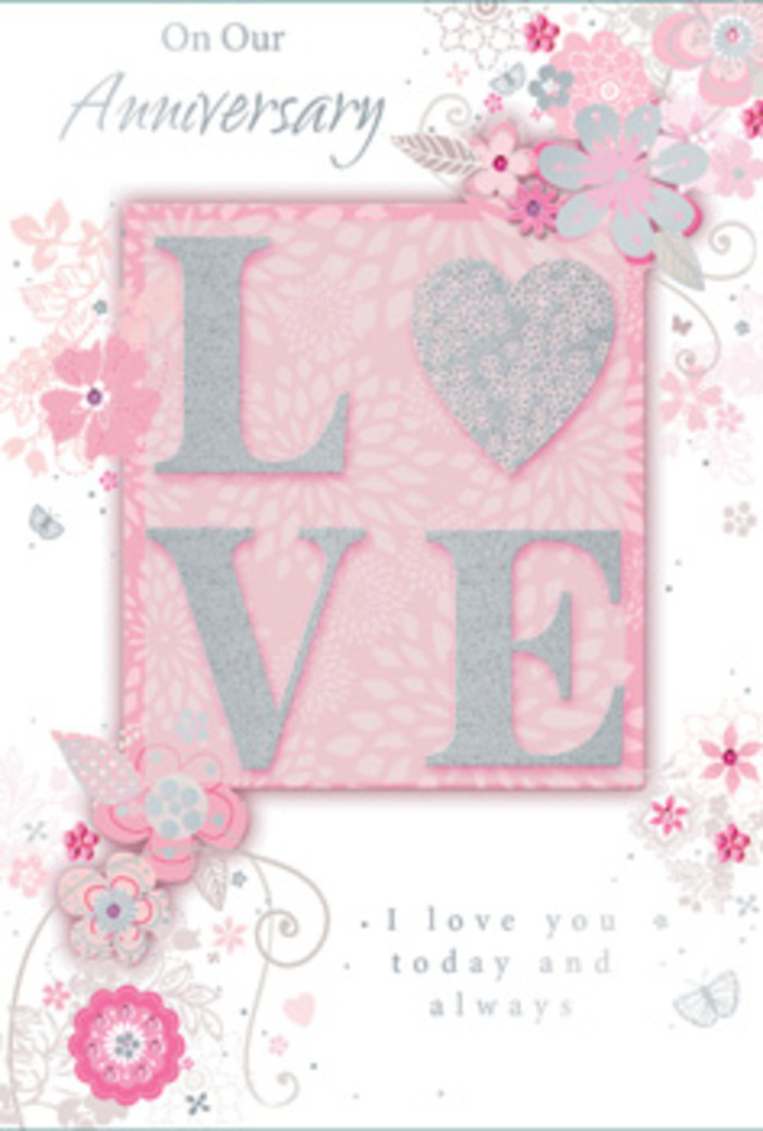 This softly luminous anniversary card feels like a quiet toast to lasting love, its design composed with the same care a florist might give to an intimate bouquet in a Watford workshop. The main colour story is one of restraint and elegance: pearly whites and gentle greys blend with powdered pink tones, giving the card a calm, almost opalescent glow. At the heart of the design, the word LOVE is rendered in raised, block capitals. Each letter is edged in fine glitter, not overpowering, but shimmering just enough to suggest candlelight glancing off glass and polished silver during a special anniversary dinner. The letters themselves rest on a soft blush-pink backdrop that appears slightly recessed, adding a sense of depth and drawing the eye to the central sentiment. Flowing outward from this focal point, a cascade of illustrated blooms, delicate leaves, and swirling vines drifts across the card's front. The flowers, outlined in pale grey and tinged with blush, mauve, and white, are shaded with light, painterly strokes, creating a sense of volume and softness. Tiny touches of silver foil highlight parts of the petals and leaf veins, catching the light like dew drops on morning roses in Cassiobury Park. The vines loop and curl gracefully, giving the floral elements movement and a sense of gentle celebration, as though the blooms are dancing in a soft breeze. A refined script message accompanies the artwork, the lettering slender and stylish, carrying simple yet heartfelt anniversary wishes. Overall, the card feels quietly luxurious and deeply personal - a paper keepsake that captures the enduring warmth, shared memories, and continuing tenderness of a relationship rooted in everyday life around Watford.
